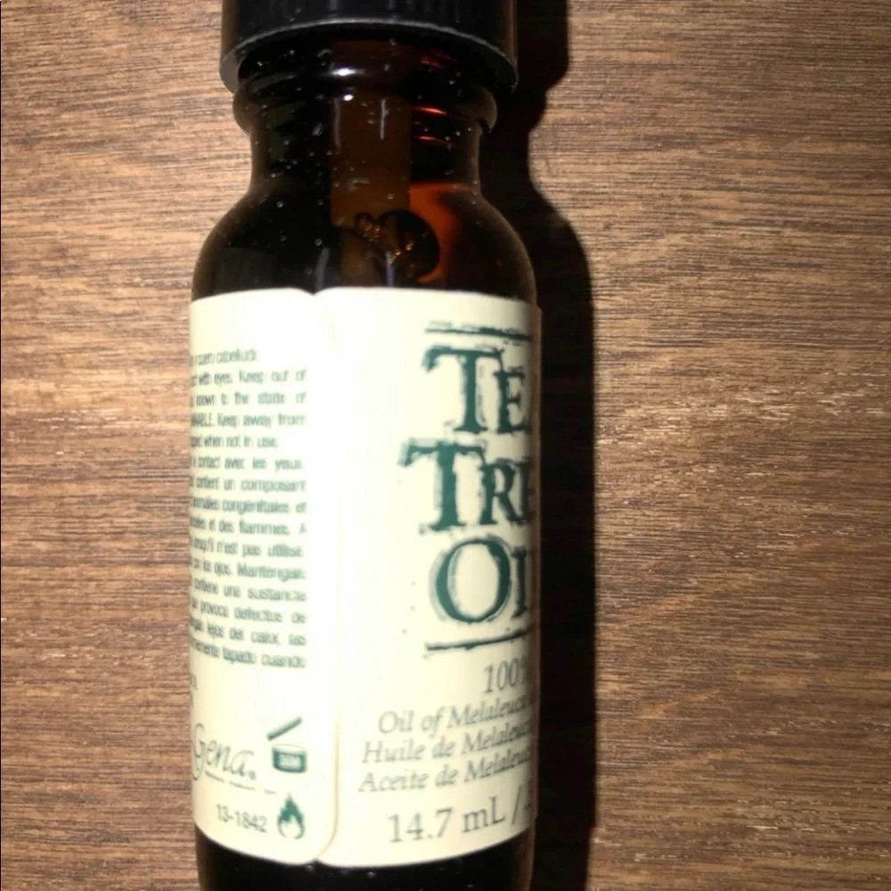 Pure tea tree oil in glass bottle